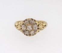An 18ct antique and old cut diamond cluster ring, finger size L/M.