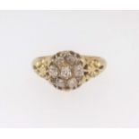 An 18ct antique and old cut diamond cluster ring, finger size L/M.