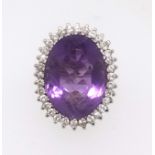 A large amethyst and diamond cluster ring set in white gold, finger size P.