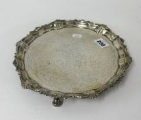 A Victorian silver solver on three curl feet with shaped border, approx 14.5oz, diameter 25cm.