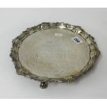 A Victorian silver solver on three curl feet with shaped border, approx 14.5oz, diameter 25cm.