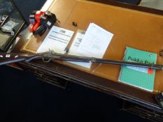 An antique percussion shot gun.