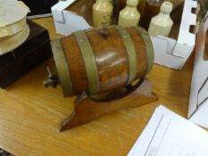 An old rum barrel reputedly from Royal William Yard Cooperage together with a porcelain Plymouth