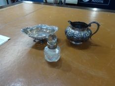 A silver mounted scent bottle, white metal cream jug no markings possibly Chinese and a silver and