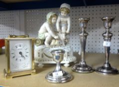 A box set of vintage nursery teawares, three silver candlesticks, modern carriage clock and