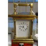 A French carriage clock and key, the dial marked 'Angelus', height 11cm, handle up.