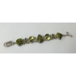 A peridot and pearl affect fashion bracelet.