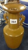 An oriental brown glazed porcelain vase with shaped 'handles' 24cm.