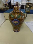 An oriental porcelain vase, baluster shaped, richly decorated with stylised flowers, with cover, six