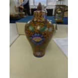 An oriental porcelain vase, baluster shaped, richly decorated with stylised flowers, with cover, six