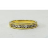 A foreign yellow gold diamond channel half eternity ring, set with brilliant cut diamonds, approx