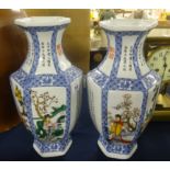 A pair of modern oriental porcelain vases with decorated panels of figures and script, height 30cm.