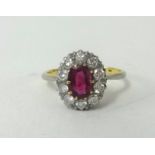An 18ct ruby and diamond cluster ring, finger size M.