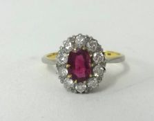 An 18ct ruby and diamond cluster ring, finger size M.