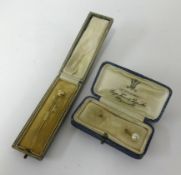 Two tie pins each set with pearl, one marked 18ct gold, cased.