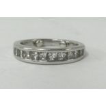 A platinum channel set diamond half band eternity ring.