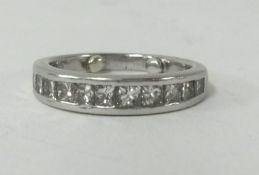 A platinum channel set diamond half band eternity ring.
