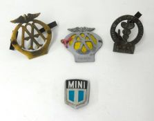 A collection of various car badges including vintage AA and BMA.