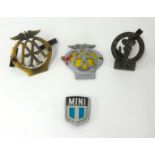 A collection of various car badges including vintage AA and BMA.