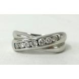 An 18ct white gold and diamond set cross over ring.