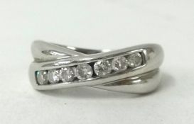 An 18ct white gold and diamond set cross over ring.