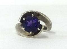 A contemporary style silver ring with a single cut amethyst.