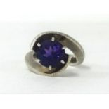 A contemporary style silver ring with a single cut amethyst.