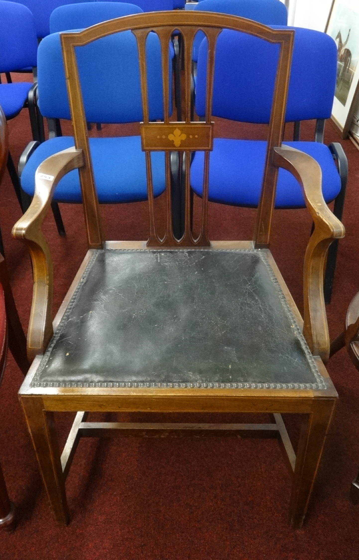 An Edwardian mahogany and inlaid elbow chair.