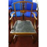 An Edwardian mahogany and inlaid elbow chair.