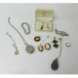 An assortment of various jewellery including two cameo pendant brooches, silver locket, cocktail
