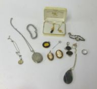An assortment of various jewellery including two cameo pendant brooches, silver locket, cocktail