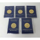 Five QEII commemorative gold medals, cased, each approx 2.50gms.