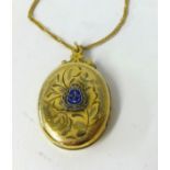 A yellow metal (gold filled locket) with enamel emblem 'RN' on a 9ct gold chain.