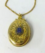 A yellow metal (gold filled locket) with enamel emblem 'RN' on a 9ct gold chain.