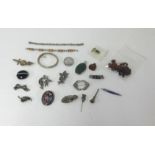 A bag of mixed jewellery and objects including arts and crafts style brooch, silver bangle and