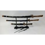 Replica trio of samurai swords on stand.