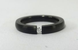 A titanium and diamond set ring.