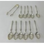 A set of Geo V Sheffield silver teaspoons and tongs of a apostle design, approx 7oz.