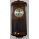 A mahogany cased wall clock with eight day chiming movement.