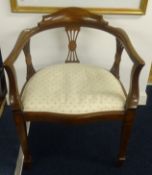 Two mahogany framed elbow chairs with round backs.