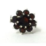 A silver and garnet style dress ring.
