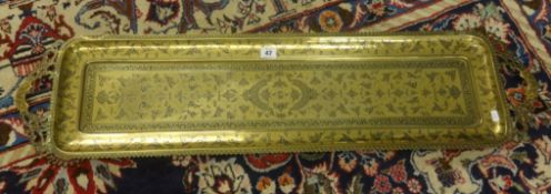 A large Middle Eastern brass handled tray, overall length 102cm.