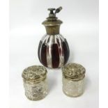 A silver mounted and coloured glass atomiser together with a pair of silver and glass small jars (