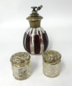 A silver mounted and coloured glass atomiser together with a pair of silver and glass small jars (