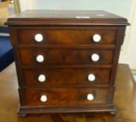 A 19th Century apprentice type miniature chest fitted with four drawers, height 29cm, width 29cm.