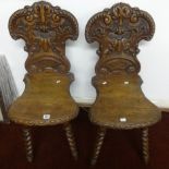 A pair of 19th Century carved oak hall chairs.
