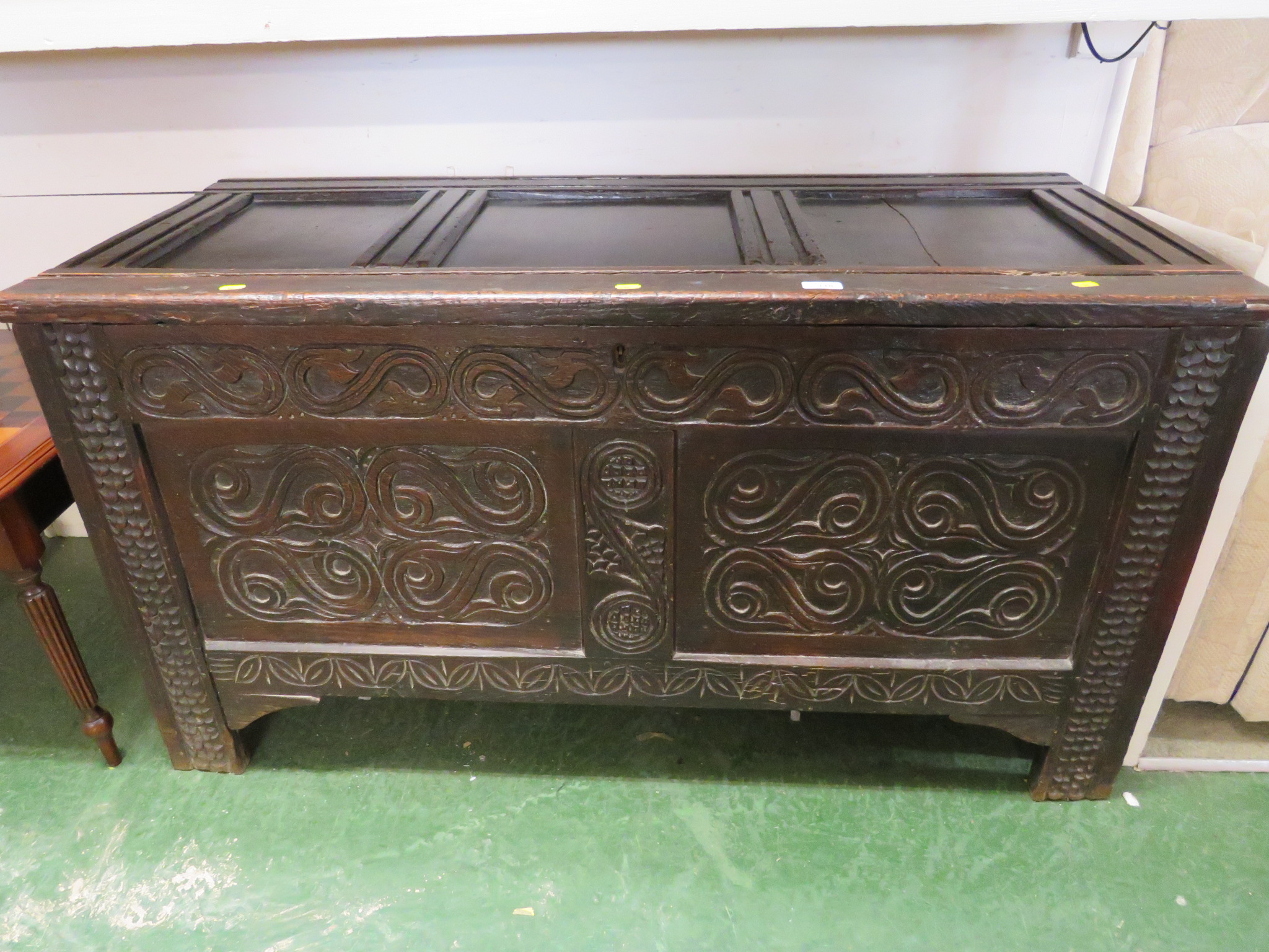 OAK COFFER WITH HEAVILY CARVED DETAILING TO FRONT