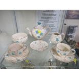 PART CERAMIC TEA SET DECORATED WITH FLOWERS INCLUDING TEAPOT, CUPS, SAUCERS AND MILK JUG