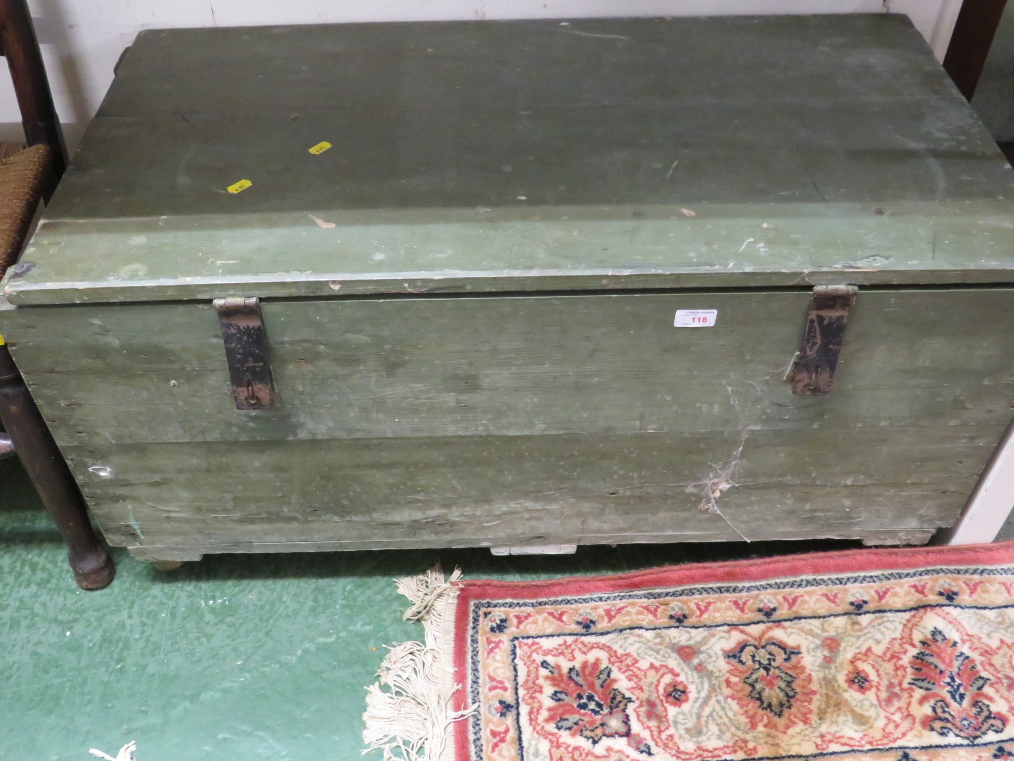 LIFT-TOP CHEST WITH THREE REMOVABLE COMPARTMENTS, PAINTED LIGHT GREEN AND STANDING ON CASTORS