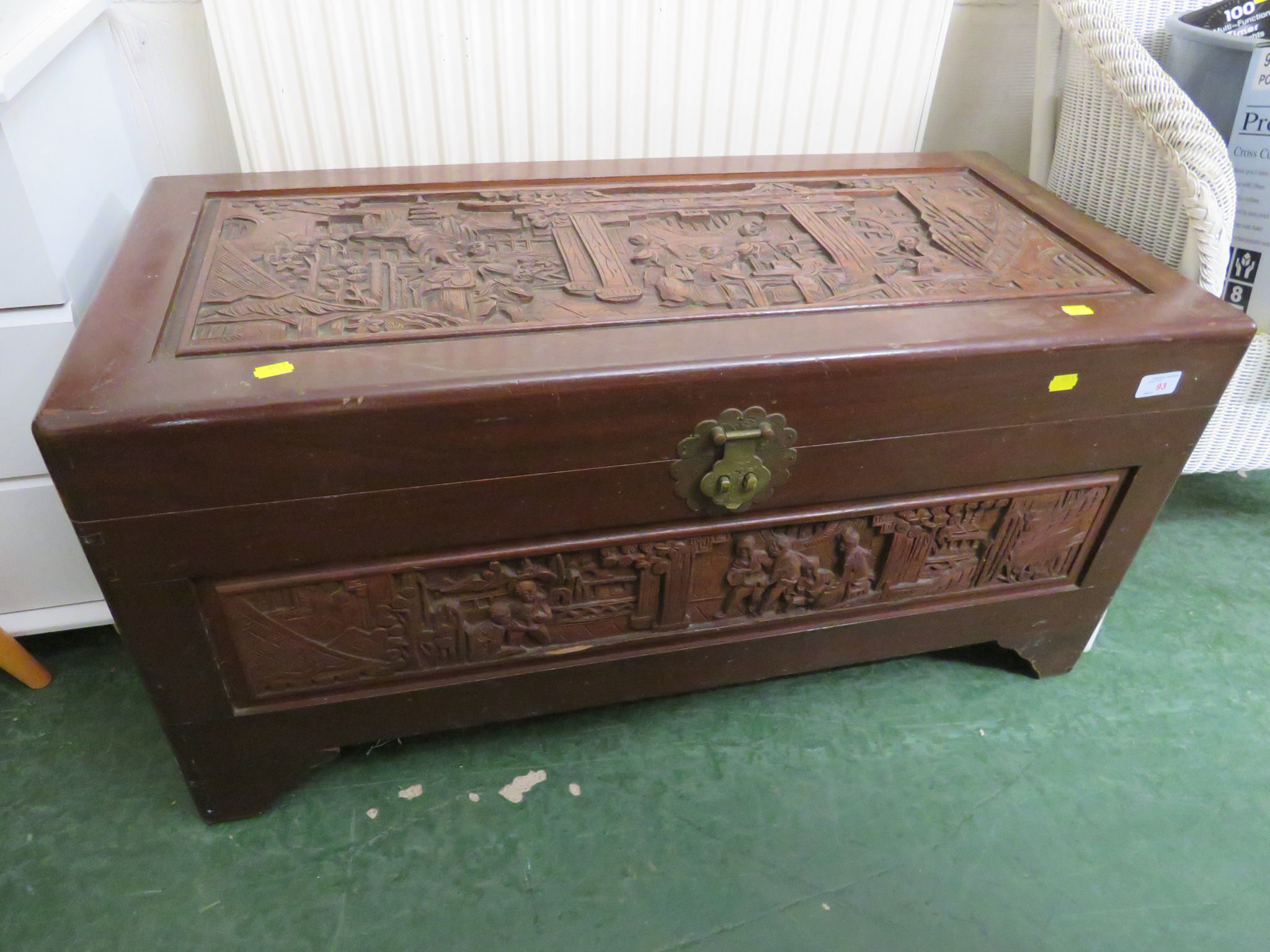 LIFT-TOP CAMPHOR WOOD CHEST HEAVILY CARVED WITH ORIENTAL SCENES